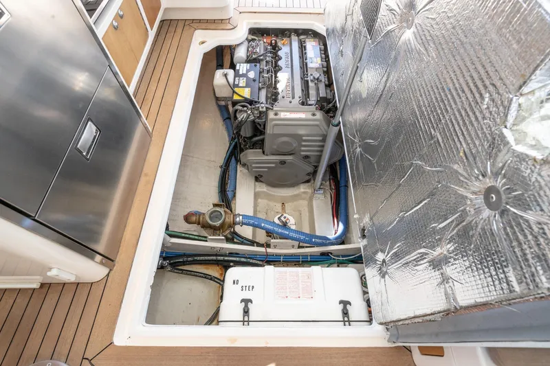 Slide: The Image of Engine compartment of a 2007 True North 38 boat, showcasing mechanical components and insulation. - 56