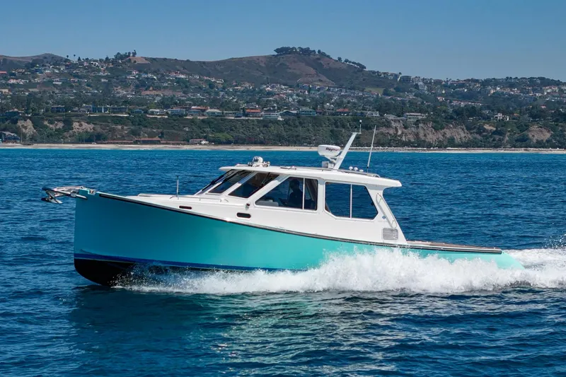 Slide: The Image of True North 38 yacht cruising on blue ocean, 2007 model, with American flag. - 6