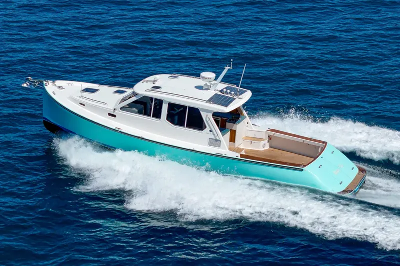Slide: The Image of 2007 True North 38 yacht with open deck, cruising on blue ocean waters. - 7