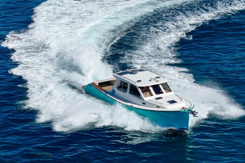 Slide: The Image of A 2007 True North 38 yacht cruising on clear blue ocean waters. - 8