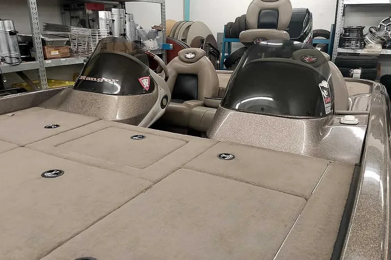 Slide: The Image of 2003 Ranger 521DVX Comanche boat interior with dual consoles and storage compartments. - 11