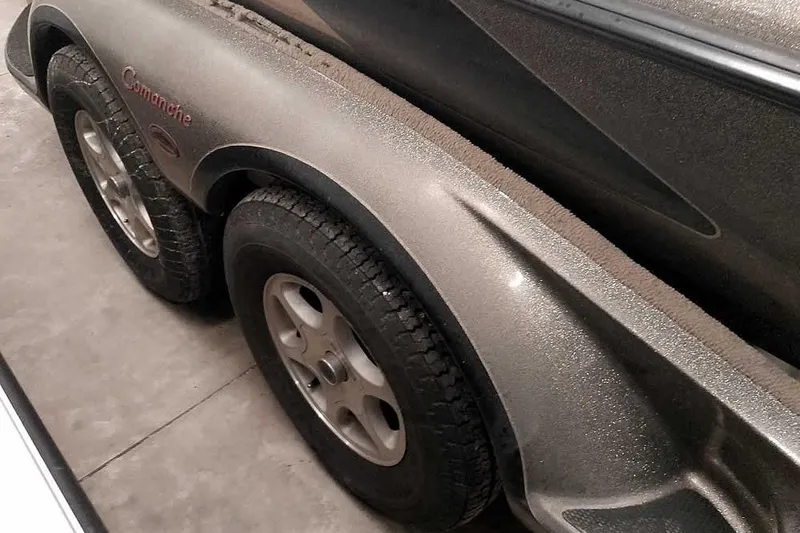 Slide: The Image of 2003 Ranger 521DVX Comanche trailer with dual wheels, parked indoors. - 12