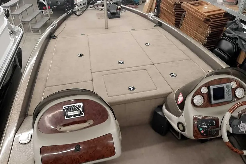 Slide: The Image of 2003 Ranger 521DVX Comanche boat interior with control panel and storage compartments. - 13