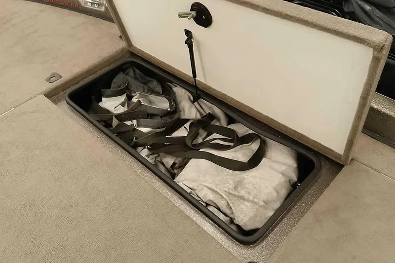 Slide: The Image of Storage compartment in 2003 Ranger 521DVX Comanche boat, containing folded gear. - 17