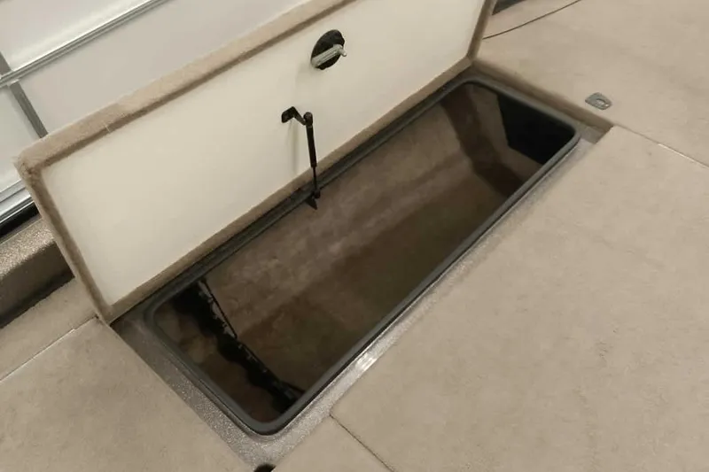 Slide: The Image of Open storage compartment in 2003 Ranger 521DVX Comanche boat, beige interior. - 19