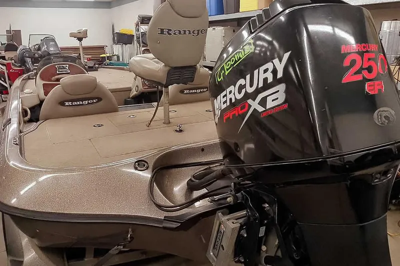 Slide: The Image of 2003 Ranger 521DVX Comanche boat with Mercury 250 Pro XB engine in a garage. - 2