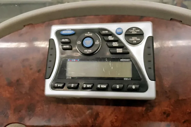 Slide: The Image of 2003 Ranger 521DVX Comanche dashboard with a marine stereo system. - 24
