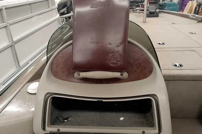 Slide: The Image of 2003 Ranger 521DVX Comanche boat interior with storage compartment and seat. - 25