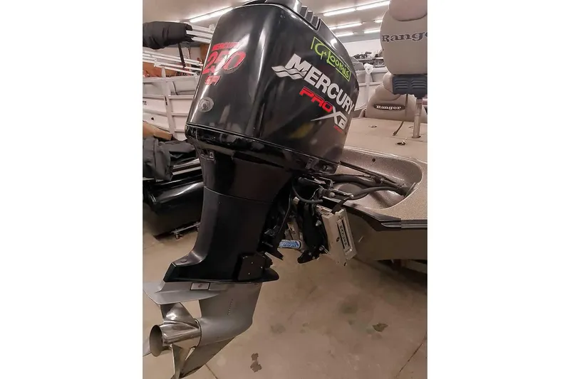 Slide: The Image of 2003 Ranger 521DVX Comanche with Mercury Pro XB outboard motor in a garage setting. - 3