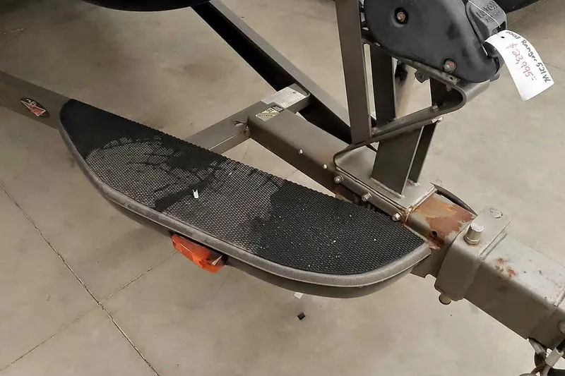 Slide: The Image of Trailer step of a 2003 Ranger 521DVX Comanche boat, showing wear and rust. - 8