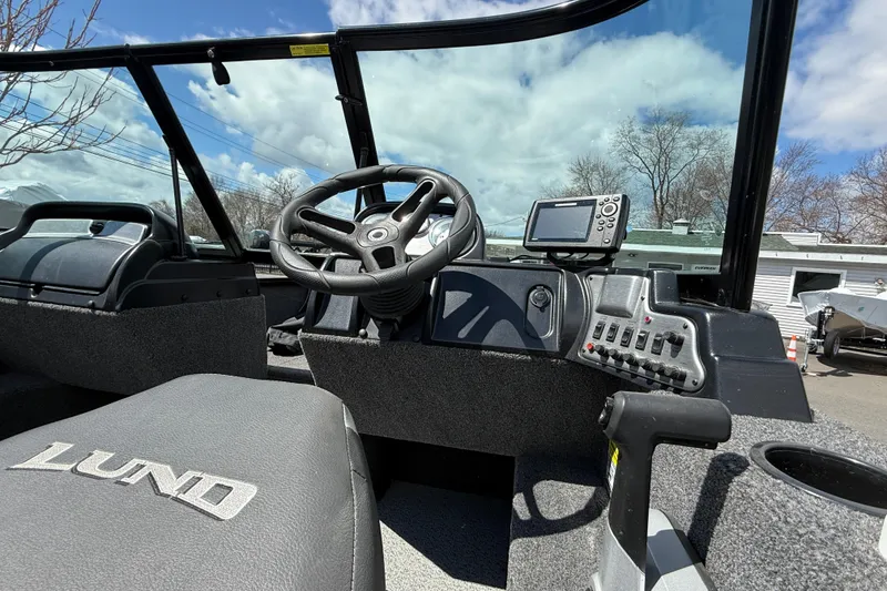 Slide: The Image of 2021 Lund 1650 Rebel XL Sport boat interior with steering wheel and control panel. - 11