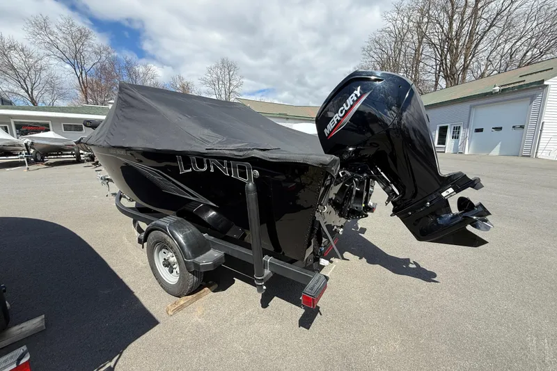 Slide: The Image of 2021 Lund 1650 Rebel XL Sport boat with Mercury outboard motor, covered and on trailer. - 16