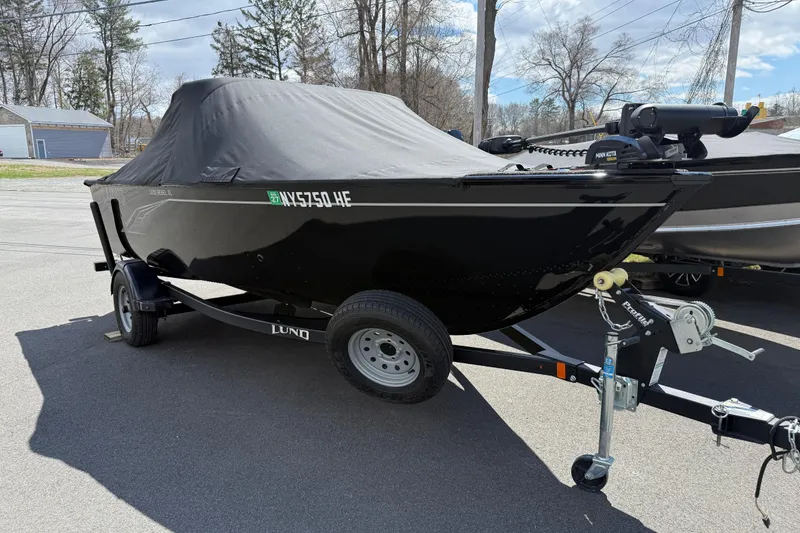 Slide: The Image of 2021 Lund 1650 Rebel XL Sport boat on trailer, covered, parked outdoors. - 18