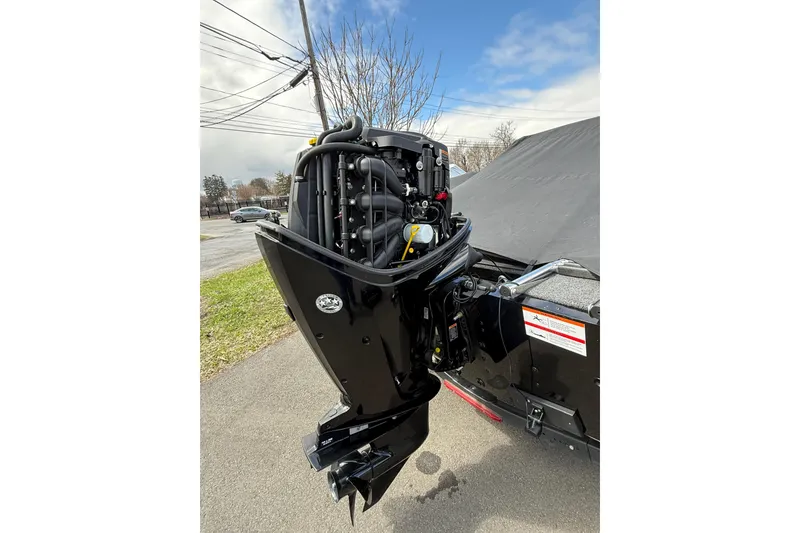 Slide: The Image of 2021 Lund 1650 Rebel XL Sport boat motor, parked outdoors on a cloudy day. - 19