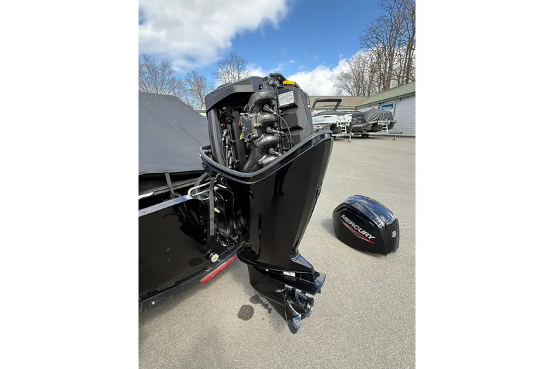 Slide: The Image of 2021 Lund 1650 Rebel XL Sport boat with Mercury outboard motor, cover removed. - 20