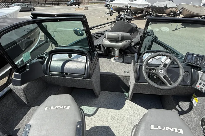Slide: The Image of 2021 Lund 1650 Rebel XL Sport boat interior with steering wheel and seating. - 3