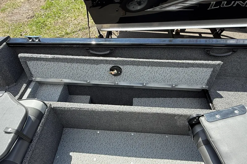 Slide: The Image of 2021 Lund 1650 Rebel XL Sport boat interior with open storage compartment. - 4