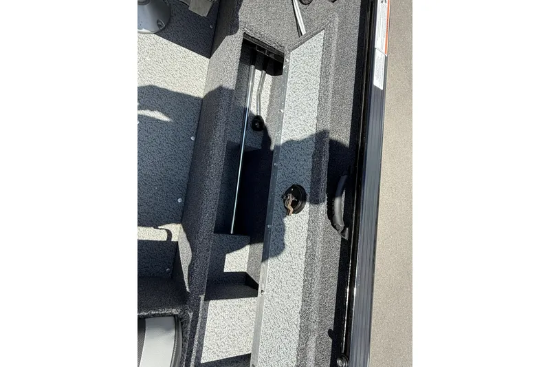 Slide: The Image of 2021 Lund 1650 Rebel XL Sport boat interior with storage compartment. - 5