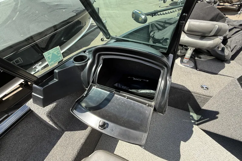 Slide: The Image of 2021 Lund 1650 Rebel XL Sport boat interior with open storage compartment and seating. - 6