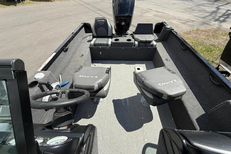 Slide: The Image of 2021 Lund 1650 Rebel XL Sport boat interior with steering wheel and seating. - 7