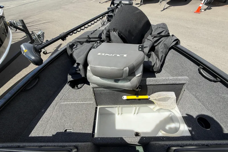 Slide: The Image of 2021 Lund 1650 Rebel XL Sport boat interior with seat, storage, and fishing net. - 9