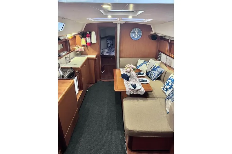 Slide: The Image of Interior of 2009 Beneteau Oceanis 40 yacht with cozy dining area and kitchen. - 17