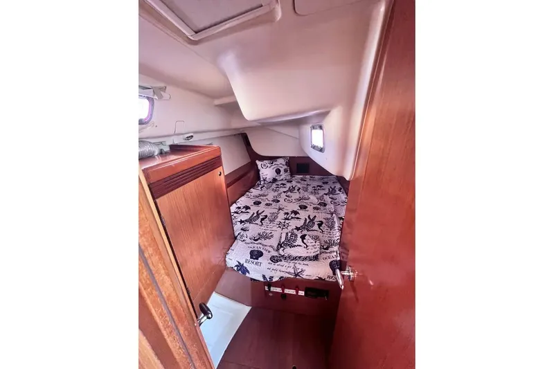 Slide: The Image of Cozy cabin interior of 2009 Beneteau Oceanis 40 sailboat with nautical-themed bedding. - 19