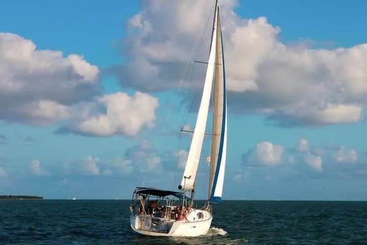 Slide: The Image of Sailing yacht Beneteau Oceanis 40, 2009 model, cruising on open sea under blue sky. - 2