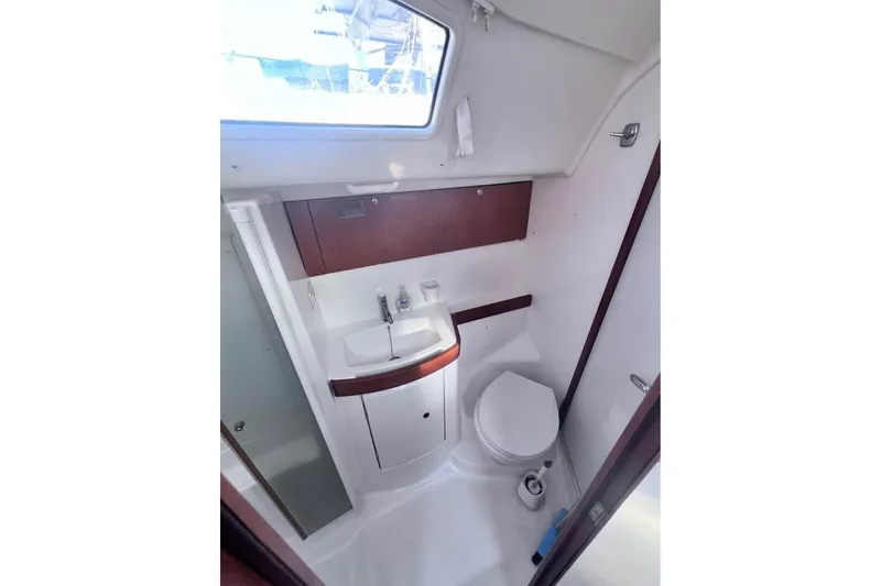 Slide: The Image of Interior of 2009 Beneteau Oceanis 40 yacht bathroom with sink, toilet, and window. - 20