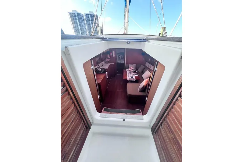 Slide: The Image of Interior view of 2009 Beneteau Oceanis 40 sailboat, showcasing cozy cabin and dining area. - 21