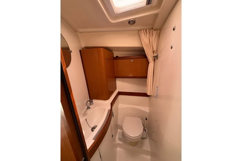 Slide: The Image of Bathroom interior of 2009 Beneteau Oceanis 40 yacht, featuring sink and toilet. - 28