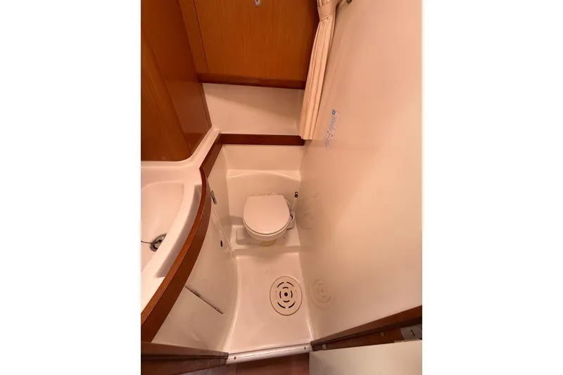 Slide: The Image of Compact bathroom in 2009 Beneteau Oceanis 40 yacht, featuring toilet and sink. - 29