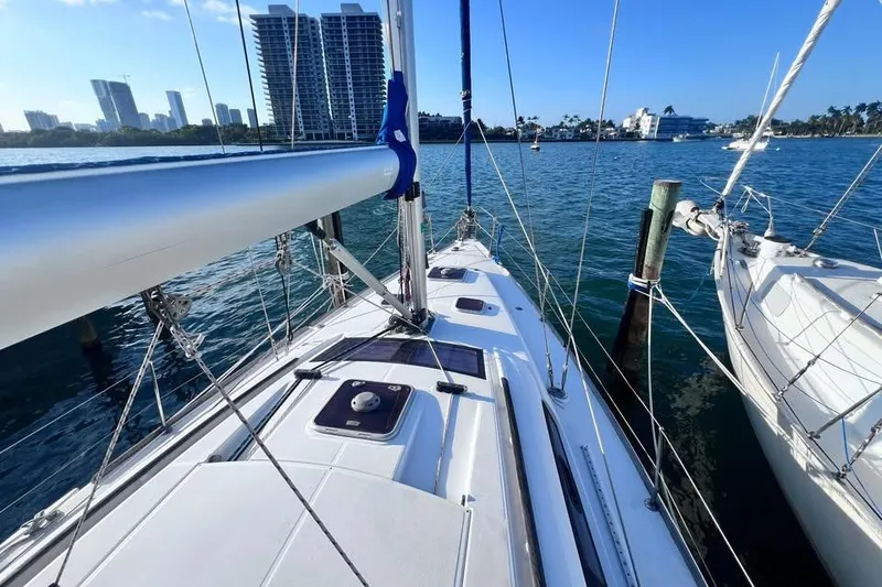 Slide: The Image of 2009 Beneteau Oceanis 40 sailboat docked with city skyline in background. - 3