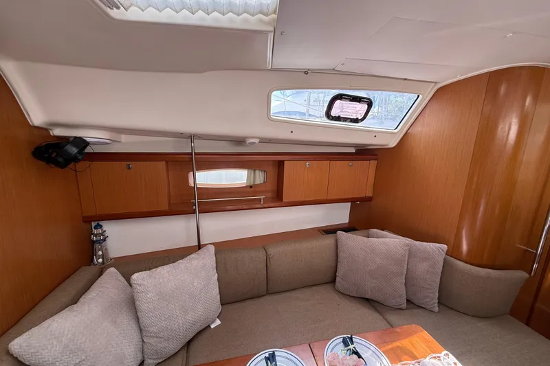 Slide: The Image of Interior of 2009 Beneteau Oceanis 40 yacht with cozy seating and wooden cabinetry. - 31