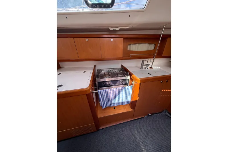 Slide: The Image of Galley kitchen in 2009 Beneteau Oceanis 40 sailboat with stove and sink. - 33