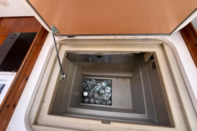 Slide: The Image of Storage compartment with water bottles on a 2009 Beneteau Oceanis 40 sailboat. - 35