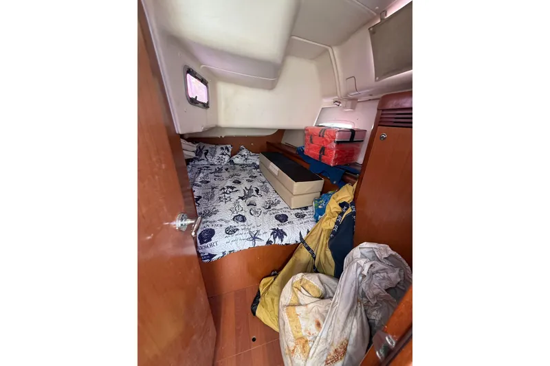 Slide: The Image of Cozy cabin interior of 2009 Beneteau Oceanis 40 sailboat with nautical bedding and storage. - 38