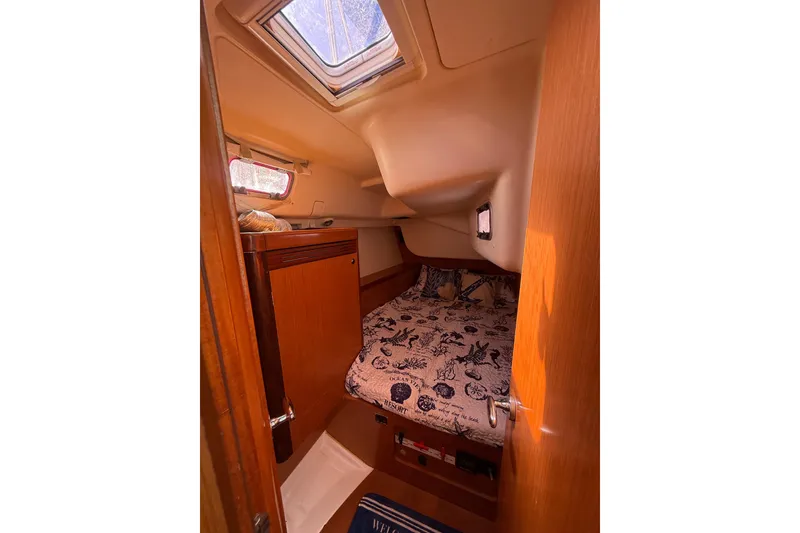 Slide: The Image of Cozy cabin interior of 2009 Beneteau Oceanis 40 sailboat with nautical bedding. - 40