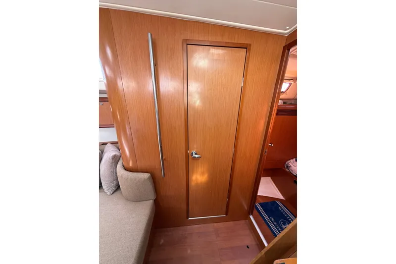 Slide: The Image of Interior of 2009 Beneteau Oceanis 40 yacht with wooden door and seating area. - 42
