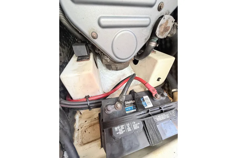 Slide: The Image of Engine compartment of a 2009 Beneteau Oceanis 40 sailboat with battery and wiring. - 48