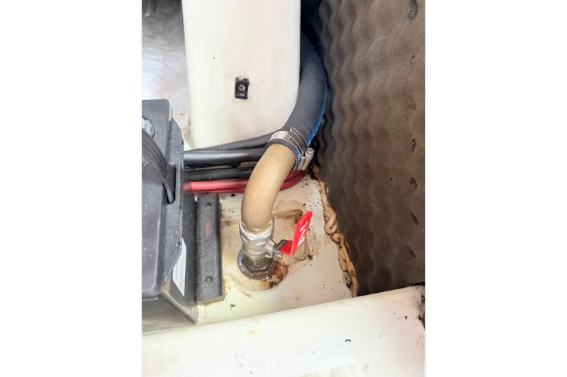 Slide: The Image of Engine compartment of a 2009 Beneteau Oceanis 40 sailboat, showing hoses and fittings. - 53