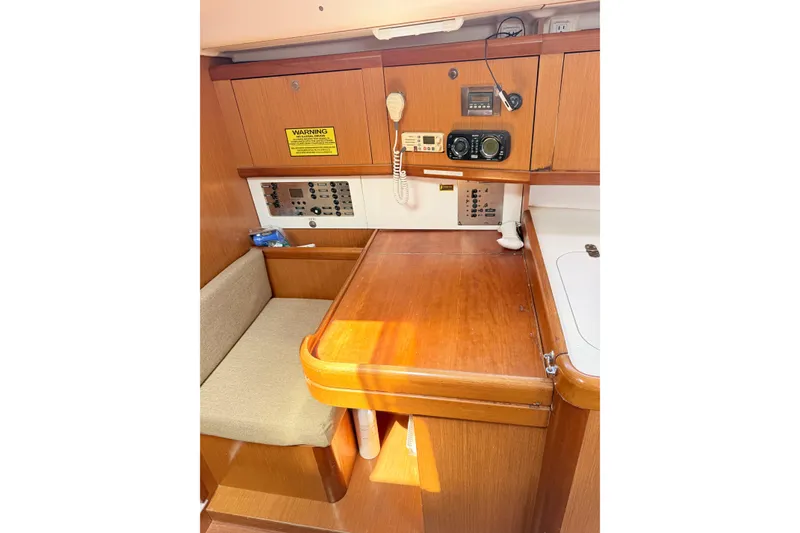 Slide: The Image of Interior of 2009 Beneteau Oceanis 40 yacht with navigation station and wooden cabinetry. - 54