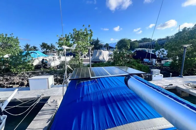 Slide: The Image of 2009 Beneteau Oceanis 40 sailboat with solar panels docked in a marina. - 6