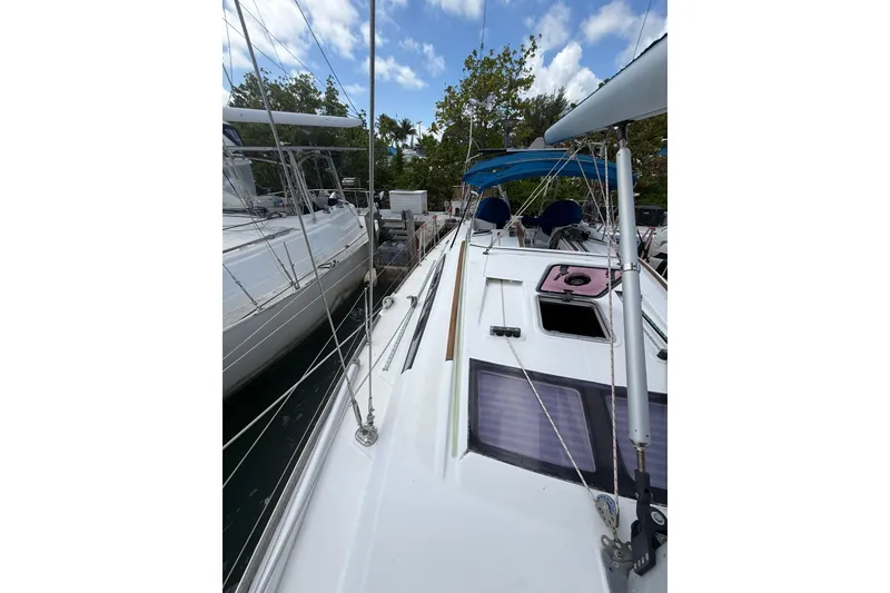 Slide: The Image of 2009 Beneteau Oceanis 40 sailboat docked, featuring sleek design and spacious deck. - 66