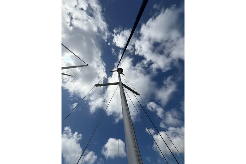 Slide: The Image of Mast of 2009 Beneteau Oceanis 40 sailboat against a cloudy blue sky. - 67