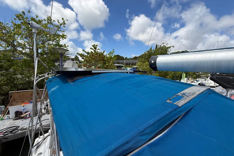 Slide: The Image of Beneteau Oceanis 40 sailboat, 2009 model, with blue cover and clear sky background. - 74