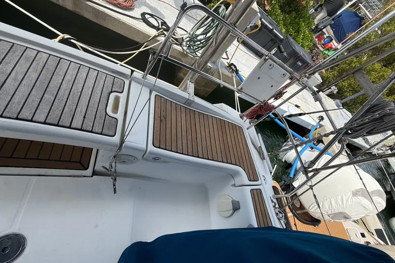 Slide: The Image of 2009 Beneteau Oceanis 40 sailboat docked, featuring teak deck and rigging details. - 79