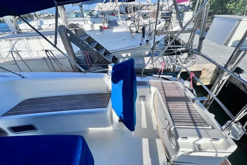 Slide: The Image of 2009 Beneteau Oceanis 40 sailboat cockpit with blue seating and wooden deck details. - 8