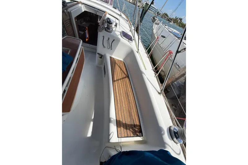 Slide: The Image of 2009 Beneteau Oceanis 40 sailboat cockpit with wooden seating and nautical equipment. - 83
