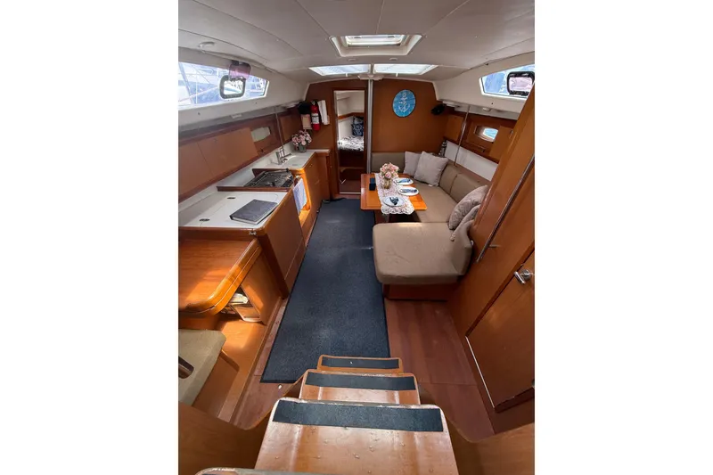 Slide: The Image of Interior of 2009 Beneteau Oceanis 40 yacht with cozy seating and kitchen area. - 84